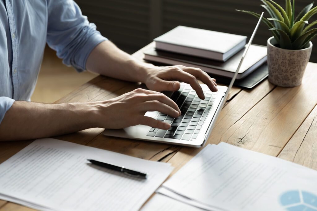 Close up of mans hands on laptop