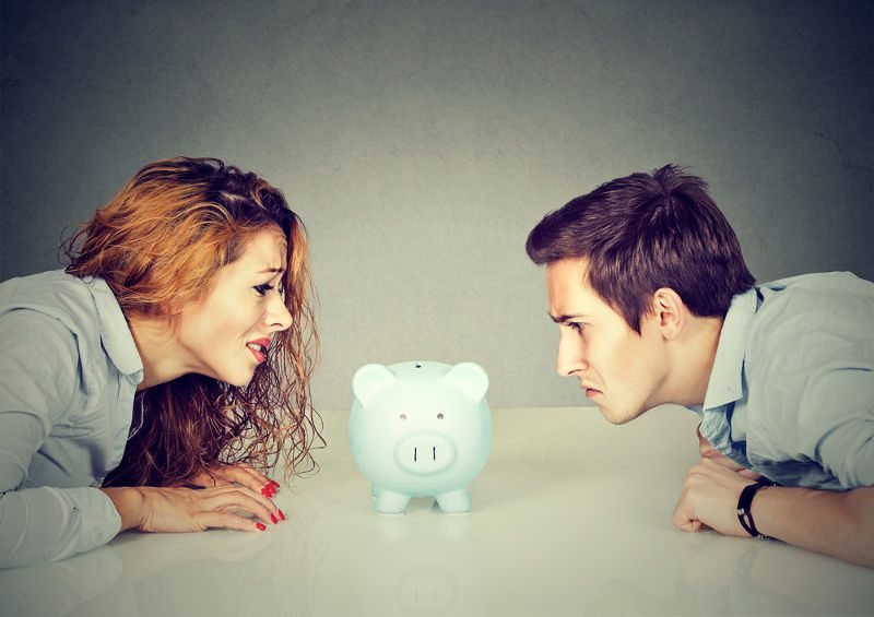 Couple stressed over piggy bank
