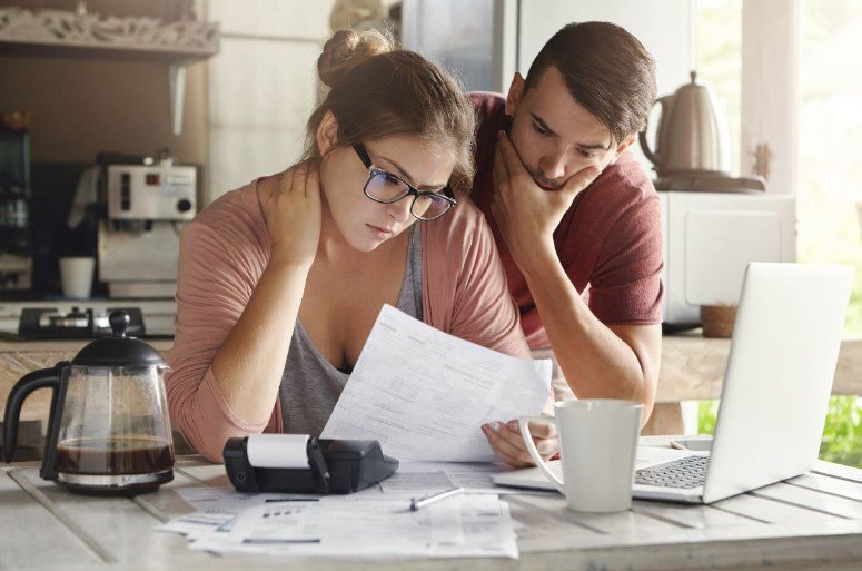 concerns couple looking at bills