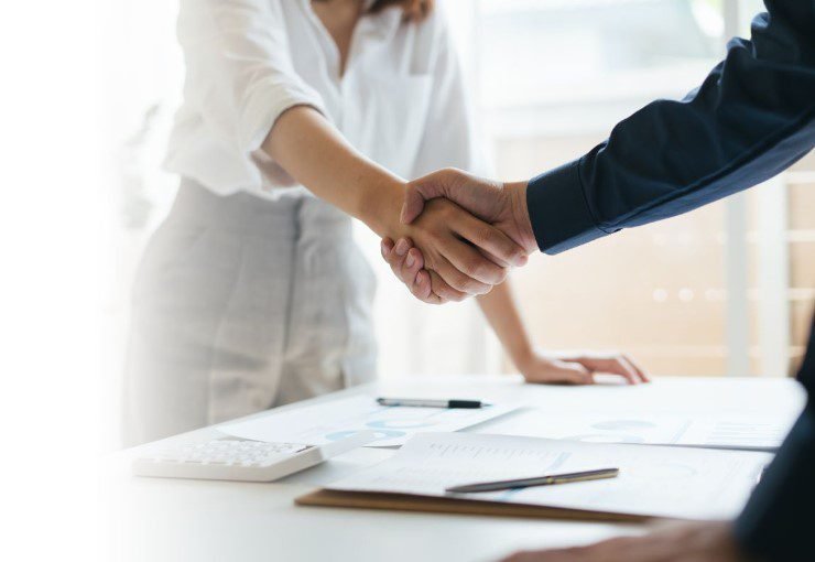 people shaking hands over agreement