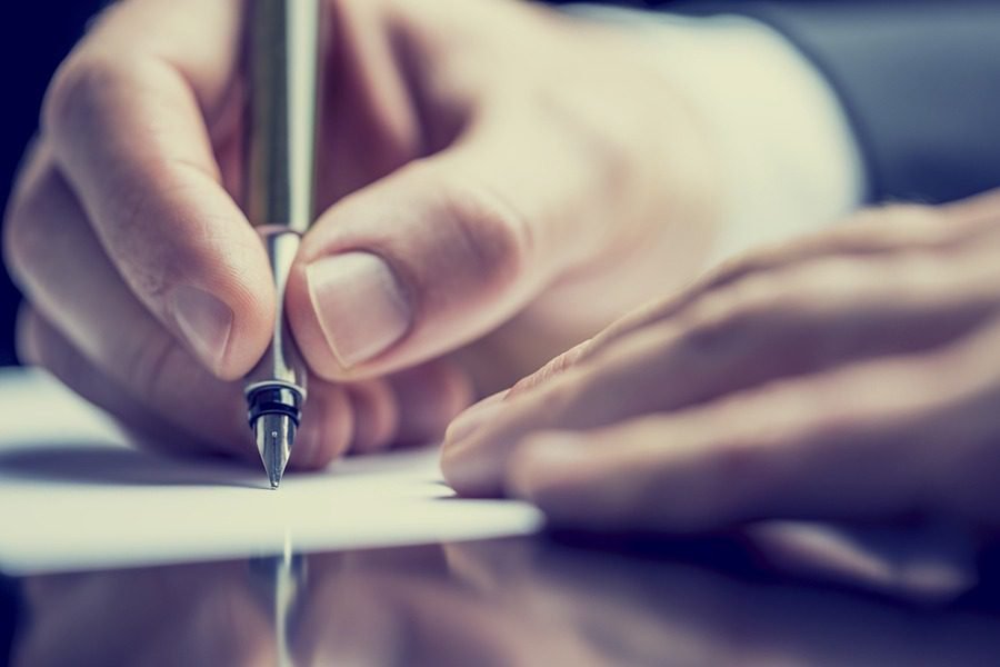 Someone signing a legal document.