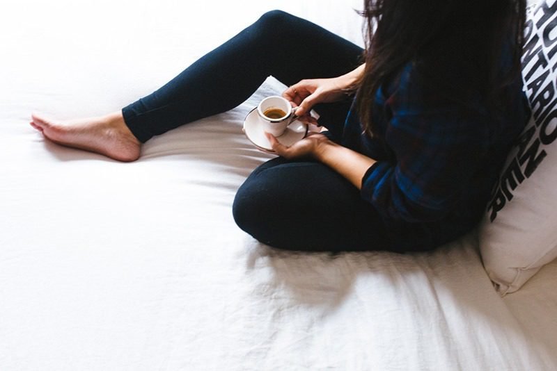 woman in bed with coffee
