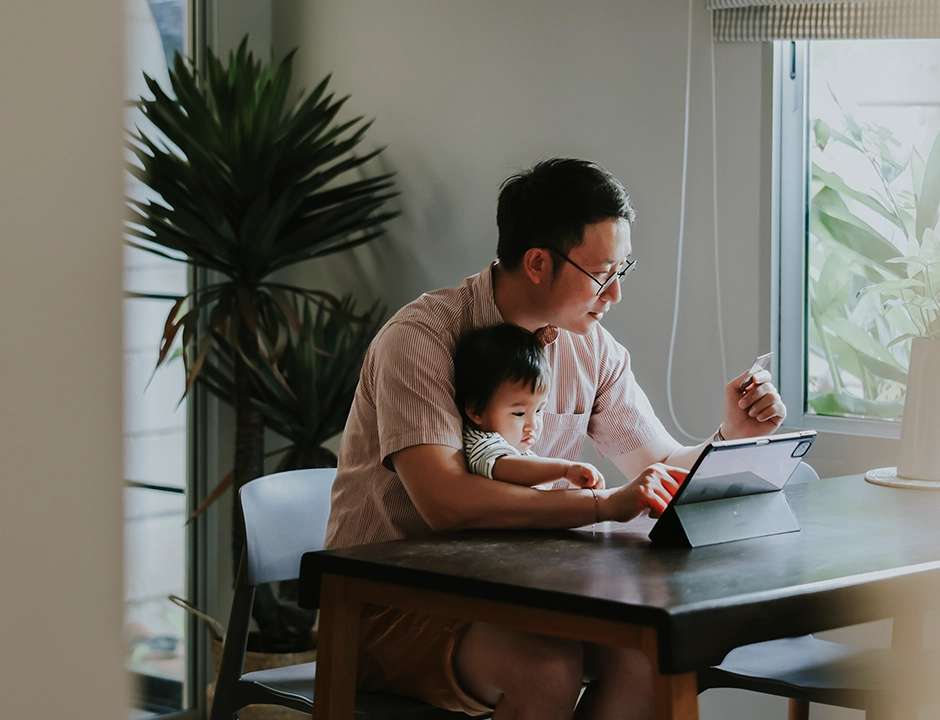 Man with child on ipad